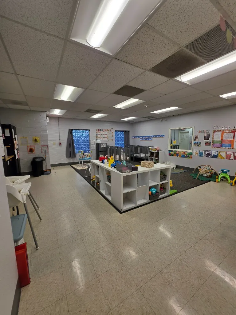 Harwell School Beaverton bright infant and toddler classroom with cribs and developmental toys